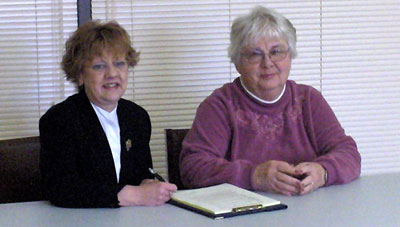 L-R Wendy Davis and Genny Vincent, chairs of the Hospice Prince Edward and Prince Edward Community Care boards of directors, sign a Memorandum of Understanding on January 26, 2006. 