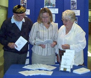 L-R: Rev. Stan Whitehouse, volunteer; Lorna Lumley, co-ordinator; and Genny Vincent, chair of the board, prepare a display of the new seniors' directory. 