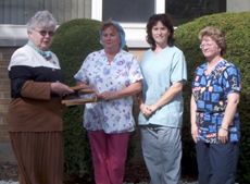 Genny Vincent, vice chair of Community Care presents certificates of appreciation to Prince Edward Memorial Hospital kitchen staff, Norma Thompson (who cooked Meals on Wheels for 16 years), Cheryl McCormick, and Laura Lee Harrison.