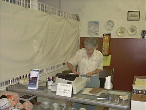 Volunteer Ruth McDonald, Thrift Shop Convenor, prepares for the rush just before the grand opening of Community Care's Thrift Shop at 281 Main Street in Picton.